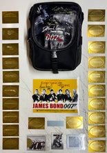 Load image into Gallery viewer, JAMES BOND - Sean Connery, Roger Moore, Timothy Dalton, Pierce Brosnan, Daniel Craig & George Lazenby Signed Crew Bag & Photo/Cards Display
