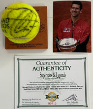 Load image into Gallery viewer, NOVAK DJOKOVIC Signed &amp; Authentic Used Tennis Ball from 2023 Roland Garros on Official Base
